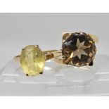 A 9ct gold retro smoky quartz ring size L1/2 and a 9ct gold citrine ring size N, weight 6.9gms