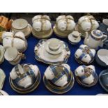 A Tuscan China teaset comprising; six cups, saucers and plates, milk jug, sugar bowl and cake plate,