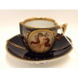 A Royal Vienna porcelain cabinet cup and saucer, of heart shape, the cup painted with winged