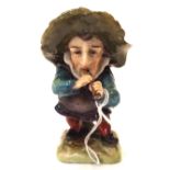 A continental Mansion House Dwarf, modelled playing a pipe, 8.7cm high Condition Report: Available