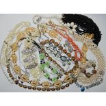 A bag full of vintage costume jewellery to include Deco clips and beads Condition Report: