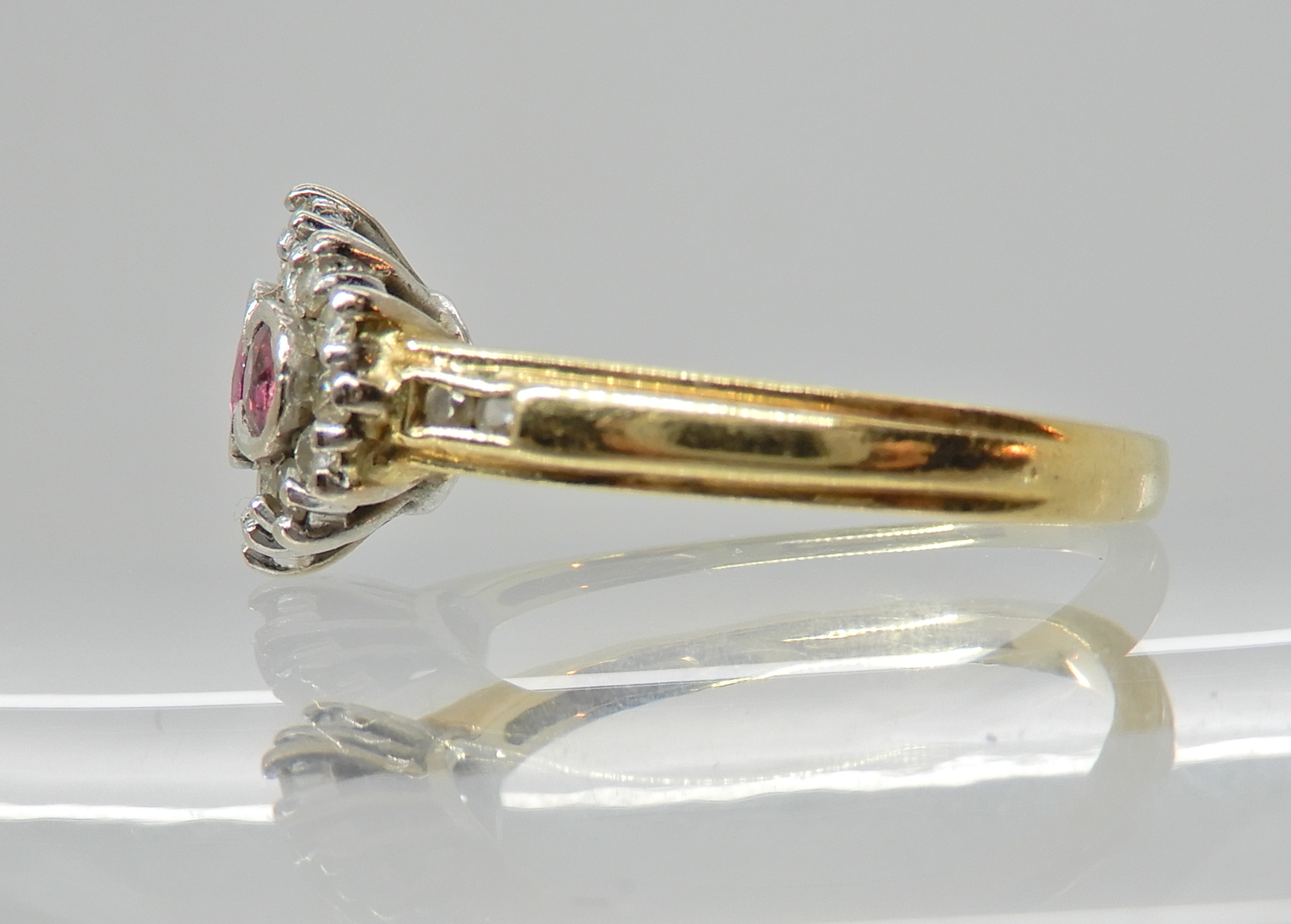 An 18ct ruby and diamond cluster ring, head size 12.4mm x 9.4mm, finger size L1/2, weight 4.5gms - Image 3 of 3