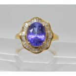 An 18ct gold tanzanite and diamond ring, head size 15.2mm x 14.2mm, tanzanite approx 9.9mm x 7.