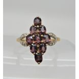 A 9ct garnet and diamond dress ring, head size 19mm x 15.5gms, size N1/2, weight 2.1gms Condition