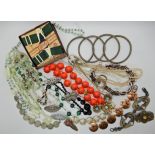 A bag full of vintage costume jewellery to include a Chinese green hardstone dragon necklace, Deco