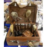 A travel toilet case fitted with silver topped jars and bottles, a dressing table set, with a pair