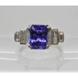 A French platinum tanzanite and diamond ring, dimensions of the tanzanite 9mm x 6.8mm x 5.5mm,