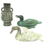 Two modern Chinese green patinated bronzed figures of ducks, 40cm long and a vase, 32cm high (3)