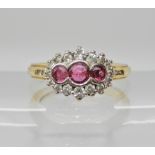 An 18ct ruby and diamond cluster ring, head size 12.4mm x 9.4mm, finger size L1/2, weight 4.5gms