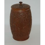 A carved oak tobacco jar and cover with white-metal interior, 24cm high, carved cigarette case and