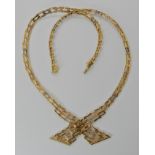 An 18ct gold decorative cross over necklace, length 41cm, weight 25.5gms Condition Report: Light