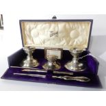 A cased silver desk set by Henry Clifford Davis, Birmingham 1909, comprising; a pair of