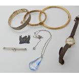 A rolled gold slave bangle, a gold plated buckle shaped bangle and other items Condition Report: