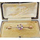 A 9ct gold red gem and diamond horseshoe brooch in original box, length of brooch 4.3cm, weight 3.