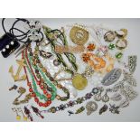 A bag full of vintage costume jewellery to include Deco clips etc Condition Report: Available upon