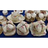 A Roslyn China handpainted teaset decorated with pink and purple flowers comprising; twelve cups,