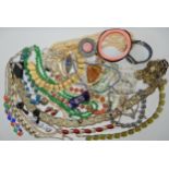 A bag full of vintage costume jewellery to include Trifari, Deco clips etc Condition Report: