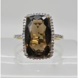 A 9ct gold diamond and smoky quartz ring, by QVC, finger size U1/2, weight 4gms Condition Report: