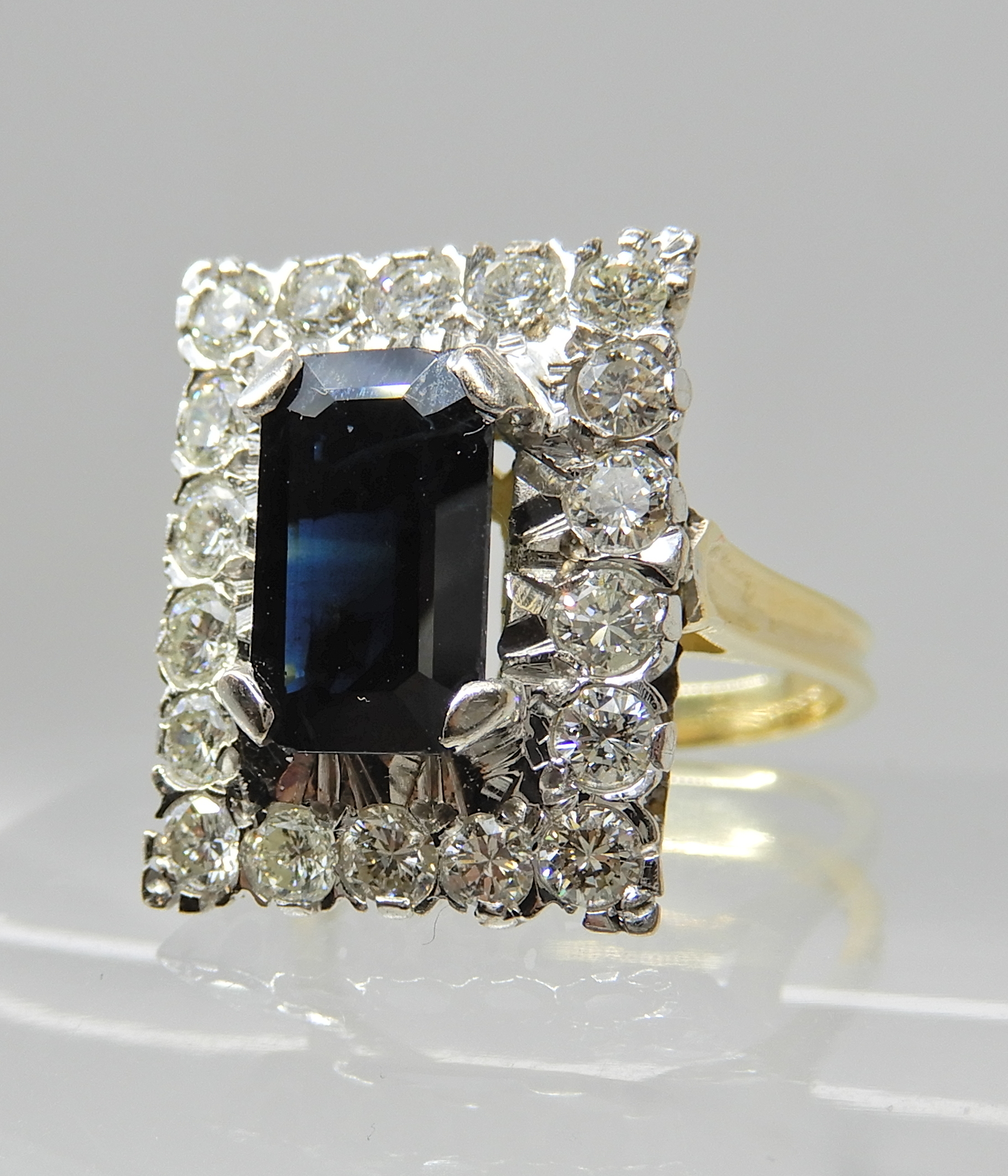 An 18ct gold sapphire and diamond oblong cluster ring, sapphire approx 10.5mm x 6.5cm x 3.7cm, - Image 2 of 4