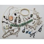 A silver charm necklace hung with many silver and white metal charms, a white metal plique a jour