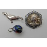 A white metal and enamel Art Nouveau brooch, a silver Ola Gorie seal brooch and a white metal