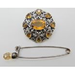 A silver citrine set brooch in the Austro Hungarian style, and a silver thistle topped kilt pin