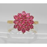 A 9ct gold ruby cluster ring, head size 13.5mm x 12.9mm, finger size N1/2, weight 2.4gms Condition
