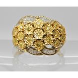 A 9ct gold white and yellow diamond flower ring, head size 14.3mm x 19mm, finger size N1/2, weight