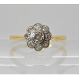 A bright yellow metal diamond flower ring of estimated approx combined 0.25cts, finger size S,