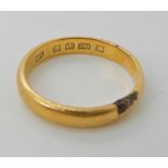A 22ct gold wedding ring, size R1/2, weight 5.1gms Condition Report: the area of black is an area of