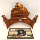 A Delft tile depicting a Viking Longship, 22.5cm long, together with a carved wood panel depicting a