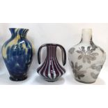 Three art glass vases to include one with purple and white stripes, 22cm high, another with