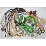 A bag full of vintage costume jewellery to include Trifari, vintage beads brooches etc Condition