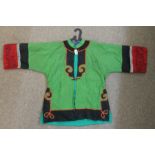 A Chinese green silk jacket with red silk embroidered cuffs Condition Report: Available upon