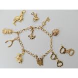A 9ct gold charm bracelet, with seven attached 9ct and yellow metal charms and three loose charms