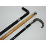 An ebony walking cane with silver collar another and a silver-topped walking cane (3) Condition