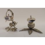 A lot comprising a silver plated mustard pot and a silver plated salt, both modelled as thistles