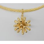 A 9ct gold flower pendant on a woven 9ct chain, diameter of the pendant 2.6cm, length of chain 45cm,
