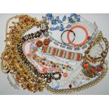 A bag full of vintage costume jewellery to include a Jean Painleve seahorse bracelet in coral, glass