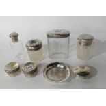 A lot comprising four silver topped jars, two small lidded boxes, a pill box and an EP dish (