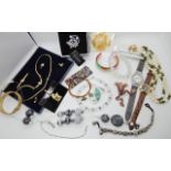 A collection of costume jewellery to include watches, two frog brooches and other items Condition