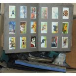 A large box of cigarette cards including albums and loose examples Condition Report: Available