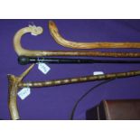 A shepherd crook and three various walking canes (4) Condition Report: Available upon request