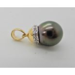 An 18ct gold black pearl and diamond pendant, length 2.1cm, weight 2.4gms Condition Report: