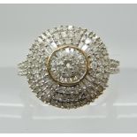 A 9ct gold baguette and brilliant cut diamond cluster ring of estimated approx diamond content 0.