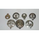 A silver brooch and six various white-metal badges Condition Report: Available upon request