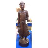 A large Burmese carved wood figure of a man wearing a Longhi, 85cm high Condition Report: He has