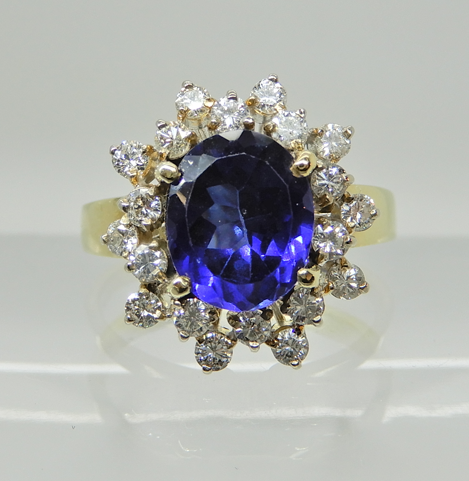 An 18ct gold faux sapphire and diamond cluster ring, head size 14.9mm x 13.8mm, size M, weight 4.