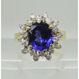 An 18ct gold faux sapphire and diamond cluster ring, head size 14.9mm x 13.8mm, size M, weight 4.