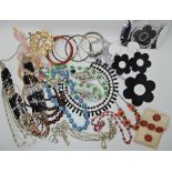 A bag full of vintage costume jewellery to include Mary Quant Iconic flower pendant and earrings